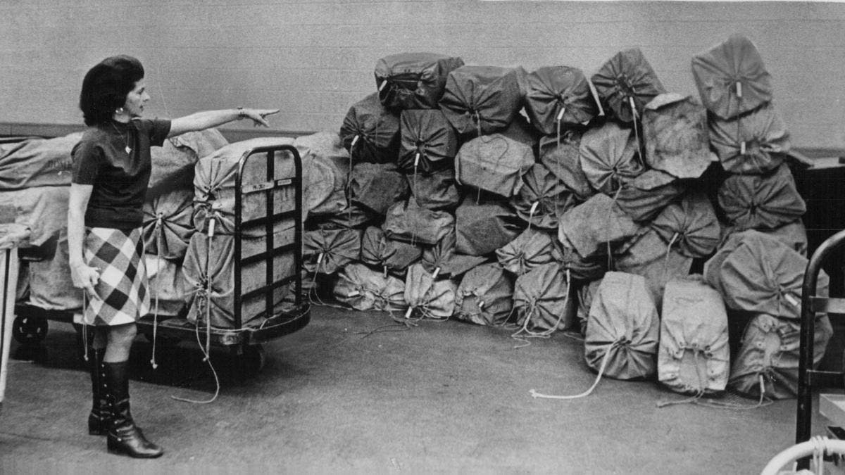 Martha Leslie, Secretary to Operations Director, points to 60 bags of parcel post stalled in Denver due to the postal strike. (Credit: Dave Buresh/The Denver Post via Getty Images)